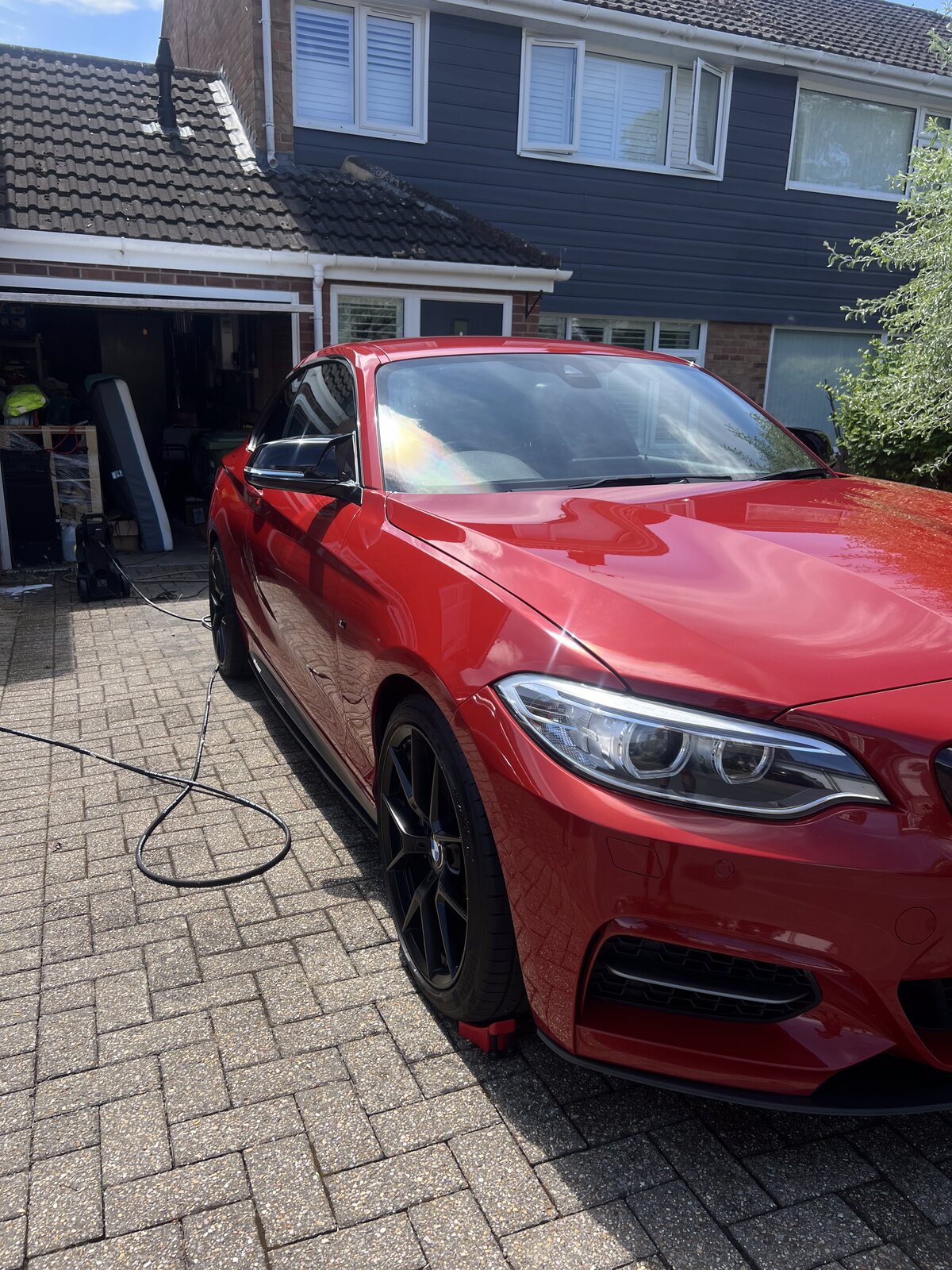Red BMW M240i gleaming after a full detail