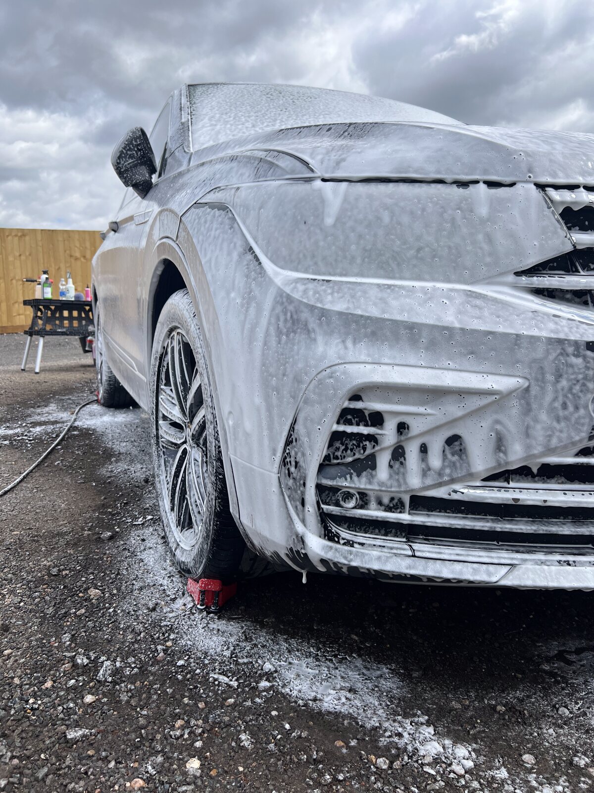 Car covered in snow foam pre-wash during exterior detail